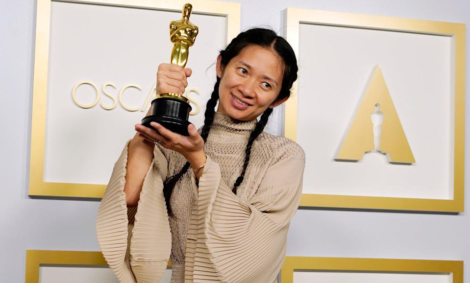 Chloé Zhao poses after winning the Academy Award for Best Picture for Nomadland (