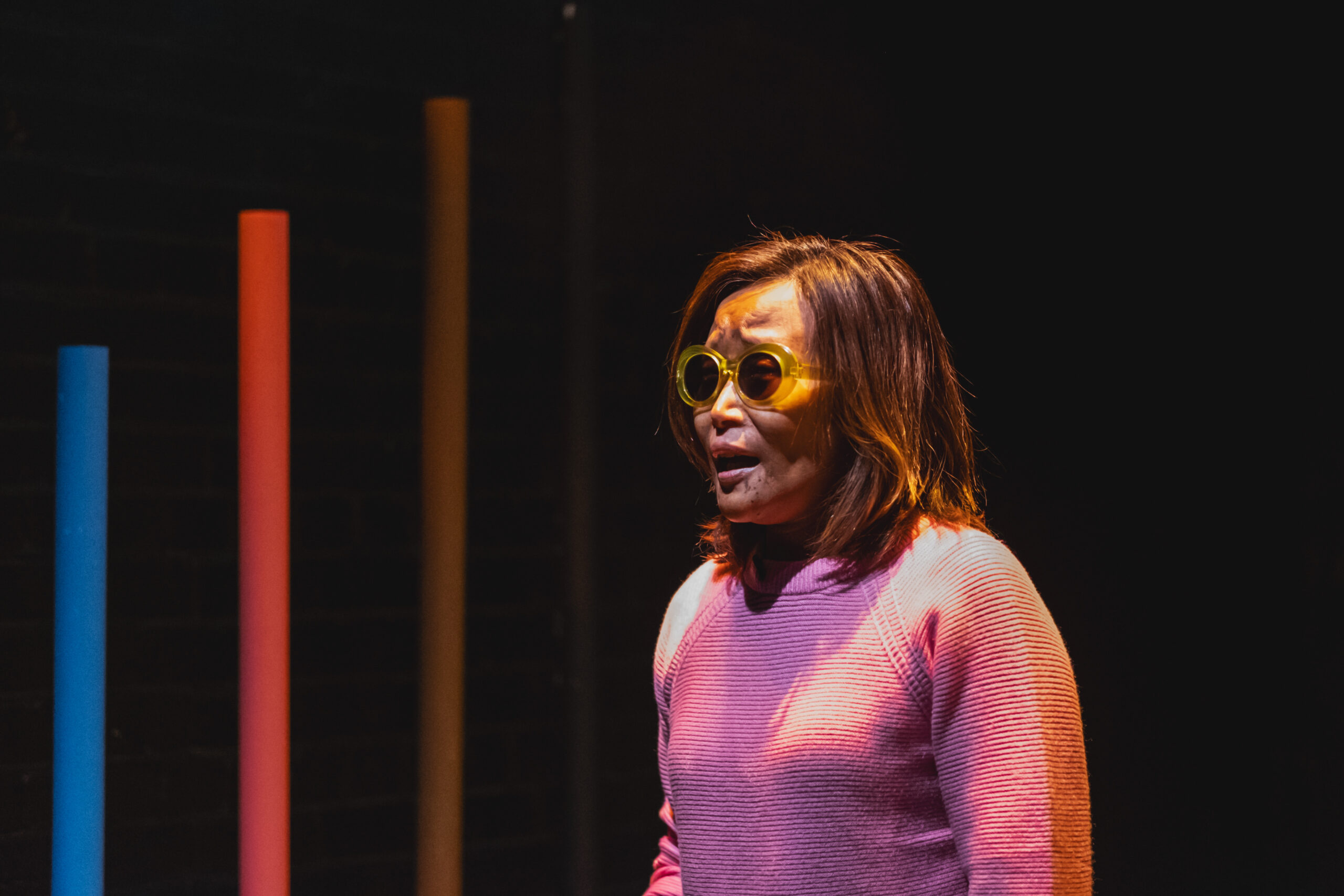 Vivian Chong, in a pink sweater, photographed during a production of her play Blind Dates