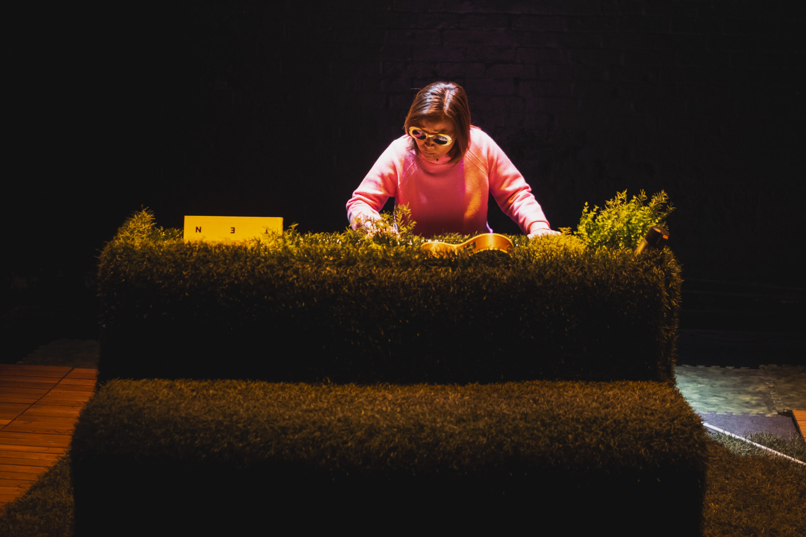 Vivian Chong, in a pink sweater, photographed during a production of her play Blind Dates