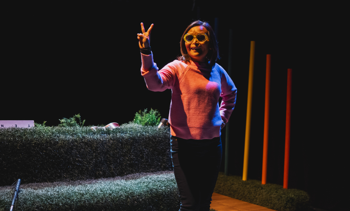 Vivian Chong, in a pink sweater, photographed during a production of her play Blind Dates