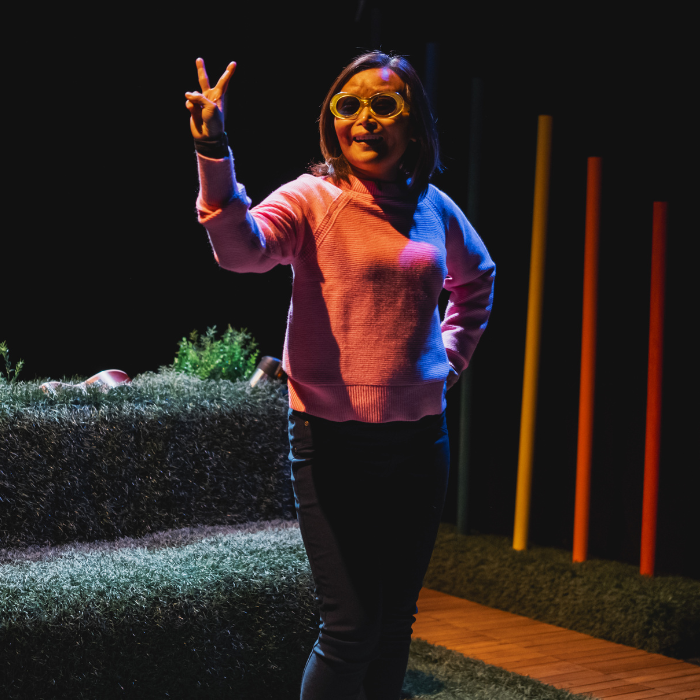 Vivian Chong, in a pink sweater, photographed during a production of her play Blind Dates